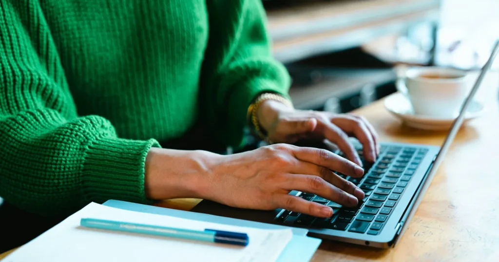 Persona consultando información en una computadora portátil antes de presentar un formulario a USCIS